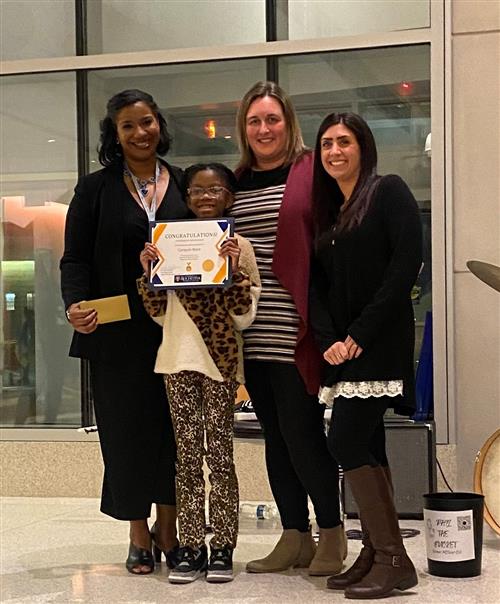 Bernabi Elementary School student Carason Ware accepts first place award in an art contest hosted by URMC.